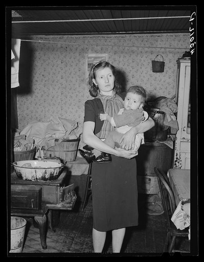 Woman and her child living in slum house in Bridgewater, Pennsylvania. Her husband is a steelworker