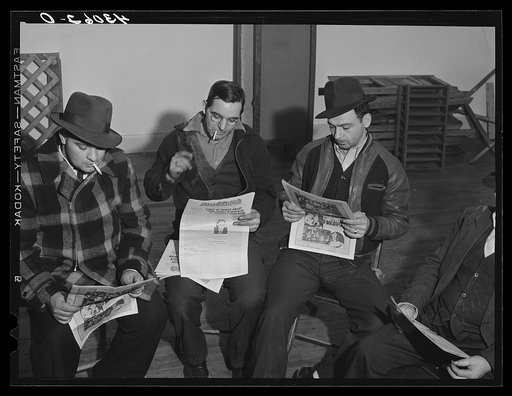 Union members reading "Steel Labor" at the union hall in Midland, Pennsylvania