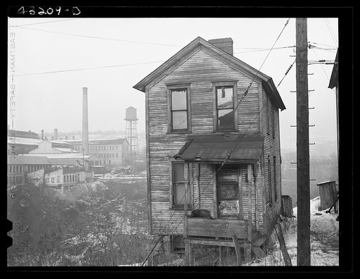 Untitled photo, possibly related to: One of the houses in the Negro quarter of Rochester, Pennsylvania. Abandoned glass works in background