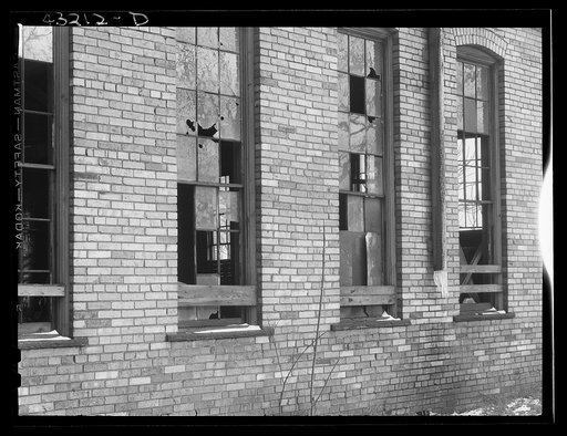 Untitled photo, possibly related to: Auto graveyard next to abandoned stove works (right) in Rochester, Pennsylvania