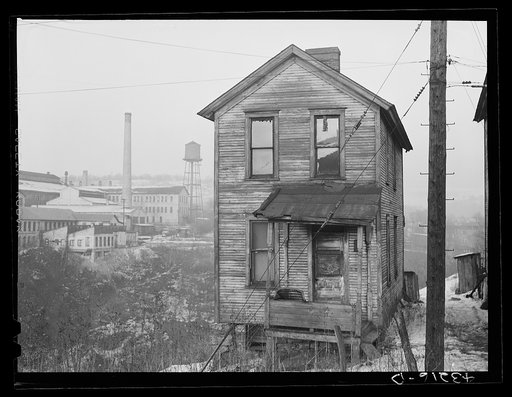 One of the houses in the Negro quarter of Rochester, Pennsylvania. Abandoned glass works in background