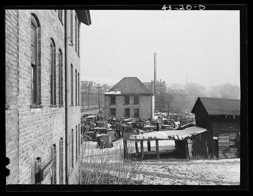 Untitled photo, possibly related to: Auto graveyard next to abandoned stove works (right) in Rochester, Pennsylvania