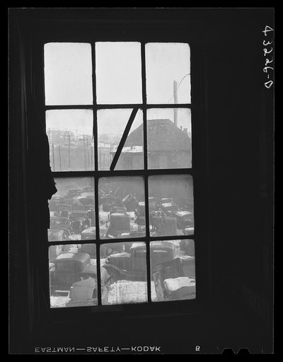 Auto graveyard seen thru a window of the abandoned Olive Stove Works, Rochester, Pennsylvania