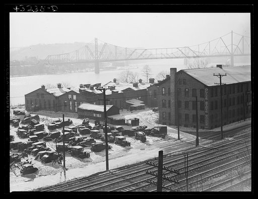 Auto graveyard next to abandoned stove works (right) in Rochester, Pennsylvania