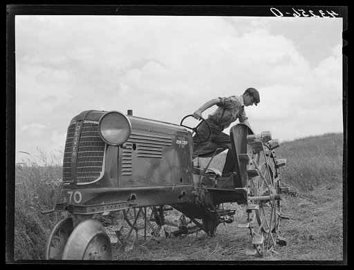 Adjusting mower on farm near Rockville, Maryland