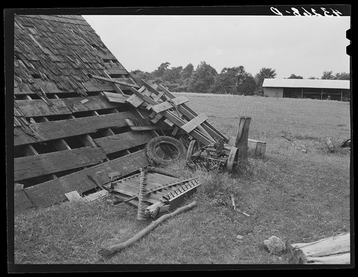 Scattered implements in barnyard on farm near Rockville, Maryland
