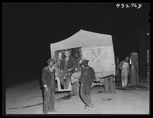 A truckload of workers from Fort Bragg, North Carolina stop at the general store at Manchester, North Carolina for gas. These are regular commuters from Greensboro, North Carolina (about ninety miles away) The truck holds about eighteen or twenty men