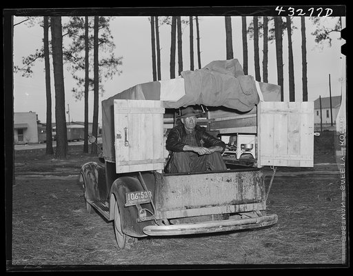 The rear end of this man's truck is his home. It includes a bed, small stove, and his personal belongings. An ex-leather worker, he was employed as a carpenter at Fort Bragg, North Carolina. Expecting to be laid off any day, he was planning to go back to his home in Hickory, North Carolina (about tw