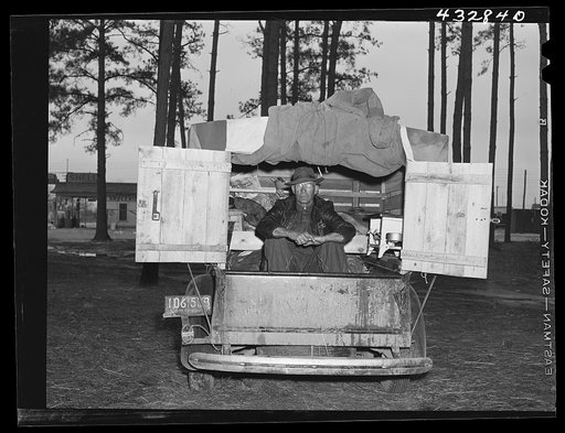Untitled photo, possibly related to: The rear end of this man's truck is his home. It includes a bed, small stove, and his personal belongings. An ex-leather worker, he was employed as a carpenter at Fort Bragg, North Carolina. Expecting to be laid off any day, he was planning to go back to his home
