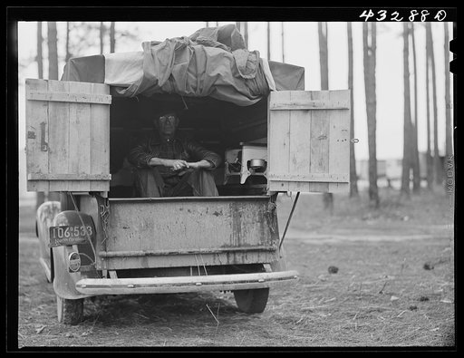 Untitled photo, possibly related to: The rear end of this man's truck is his home. It includes a bed, small stove, and his personal belongings. An ex-leather worker, he was employed as a carpenter at Fort Bragg, North Carolina. Expecting to be laid off any day, he was planning to go back to his home