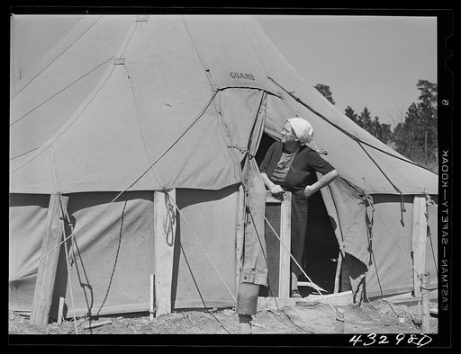Woman living in a tent in a settlement for workers at Fort Bragg, near Fayetteville, North Carolina