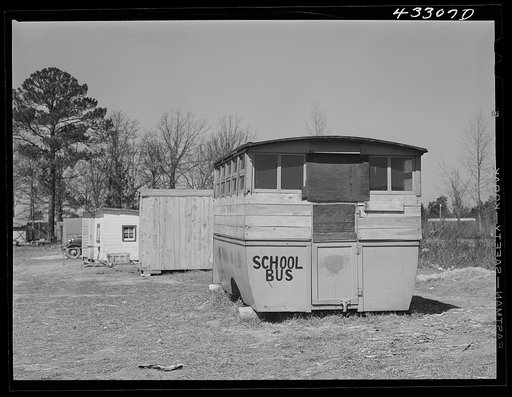 Abandoned school bus occupied by two workers from Fort Bragg, North Carolina in a settlement near the fort