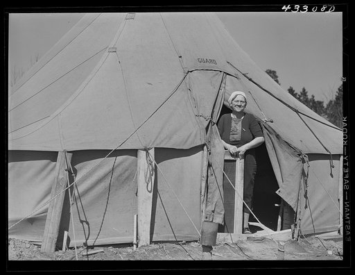 Untitled photo, possibly related to: Woman living in a tent in a settlement for workers at Fort Bragg, near Fayetteville, North Carolina