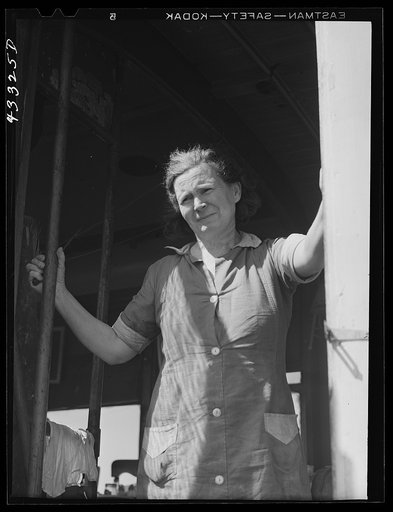 Untitled photo, possibly related to: Woman living with her family of four in an old street car. Her husband is a watchman at Fort Bragg. They used to live in Fayetteville, but rents were too high and no apartments available. On the outskirts of Fayetteville, North Carolina