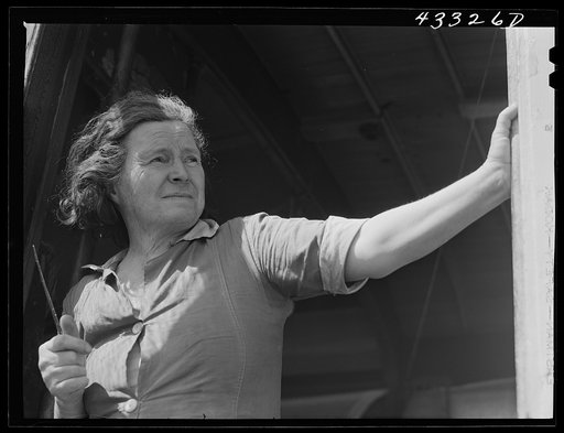 Woman living with her family of four in an old street car. Her husband is a watchman at Fort Bragg. They used to live in Fayetteville, but rents were too high and no apartments available. On the outskirts of Fayetteville, North Carolina