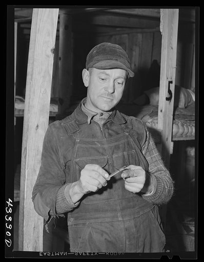 Silver Lake (vicinity), North Carolina. A worker who is employed at Fort Bragg in the doorway of a bunkerhouse in which he rents a lower berth