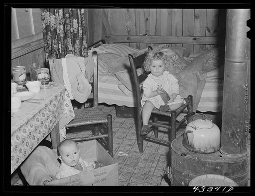 In the second story of a tobacco barn used as living quarters by family of workers from Fort Bragg, North Carolina. Near Fayetteville, North Carolina