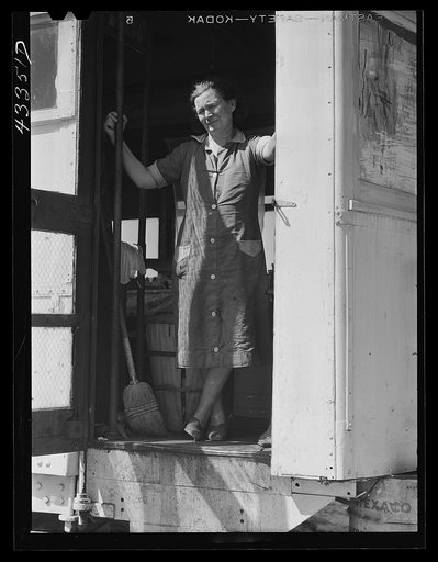 Untitled photo, possibly related to: Woman living with her family of four in an old street car. Her husband is a watchman at Fort Bragg. They used to live in Fayetteville, but rents were too high and no apartments available. On the outskirts of Fayetteville, North Carolina