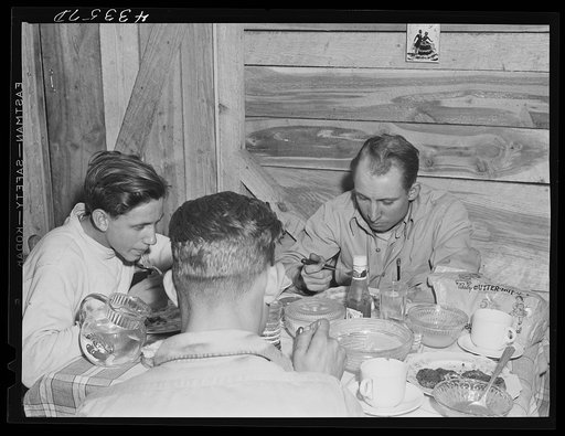 Truckers from Fort Bragg having supper in their shack near Manchester, North Carolina