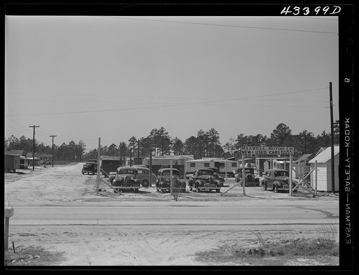 A used car lot adjacent to a trailer settlement of workers from Fort Bragg. Near Fayetteville, North Carolina