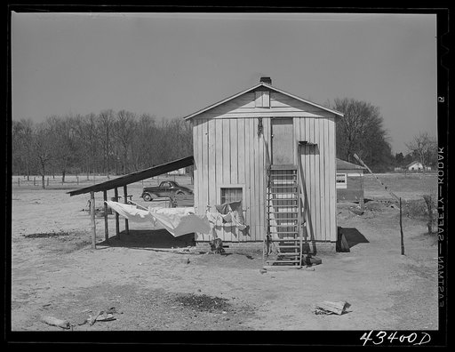 Tobacco barn converted into living quarters for families of workers from Fort Bragg. Near Fayetteville, North Carolina
