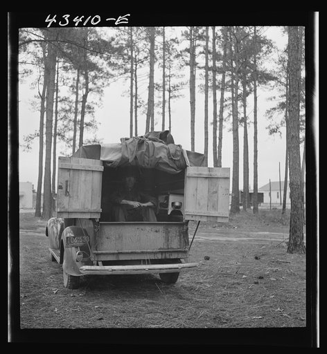 Untitled photo, possibly related to: The rear end of this man's truck is his home. It includes a bed, small stove, and his personal belongings. An ex-leather worker, he was employed as a carpenter at Fort Bragg, North Carolina. Expecting to be laid off any day, he was planning to go back to his home