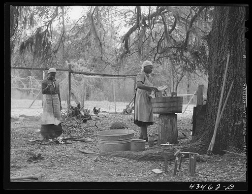 Family who had moved out of Santee-Cooper Basin, washing clothes on their "new" farm near Moncks Corner, South Carolina