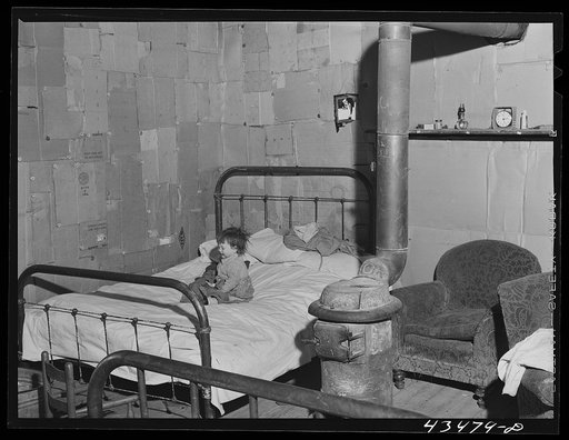 Untitled photo, possibly related to: In the home of a "squatter" family that was preparing to move off the Camp Croft area. Near Whitestone, South Carolina