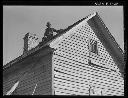 Untitled photo, possibly related to: Repairing the roof of an old tenant house to be occupied by a Negro family from the Spartanburg Army camp area. Near Whitestone, South Carolina