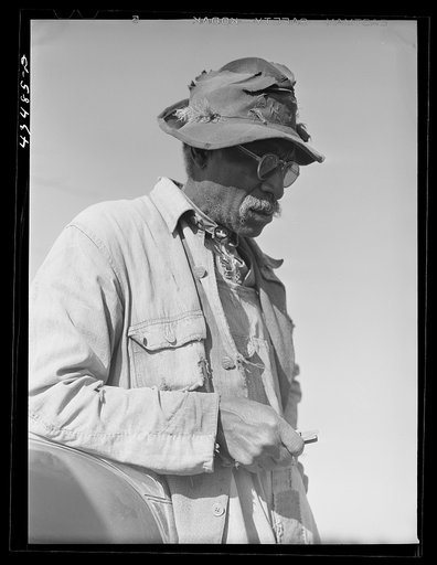 Untitled photo, possibly related to: Mr. L. A. Anderson, who owned a few acres of land in the Camp Croft area.  Although almost totally blind, he was repairing an old house to move into temporarily. Near Whitestone, South Carolina