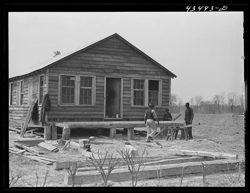 Untitled photo, possibly related to: Building a porch for a house that had been carried out of the Santee-Cooper basin by a Negro family. Near Bonneau, South Carolina region