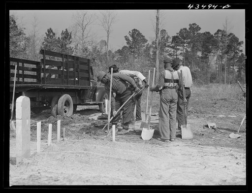 Digging new graves for a cemetery that is being moved out of the Santee-Cooper basin. Near Bonneau, South Carolina
