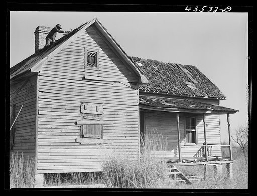 Repairing the roof of an old tenant house to be occupied by a Negro family from the Spartanburg Army camp area. Near Whitestone, South Carolina