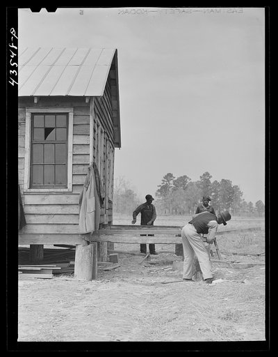 Building a porch for a house that had been carried out of the Santee-Cooper basin by a Negro family. Near Bonneau, South Carolina region