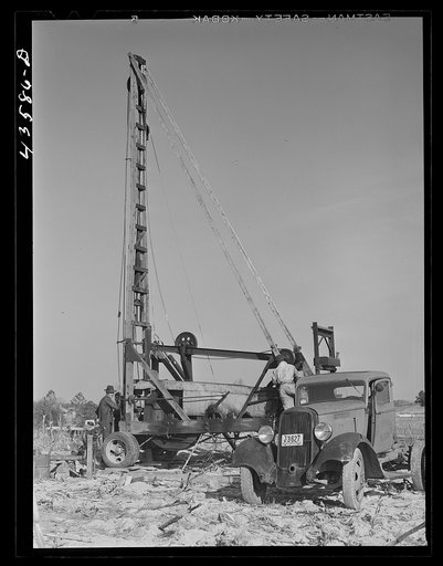 Digging a well for families moving into FSA (Farm Security Administration) prefabricated houses from the Camp Croft area. Pacolet, South Carolina region