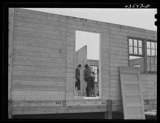 Putting up an inside wall in prefabricated houses for farmers moving out of the Camp Croft area. Pacolet, South Carolina
