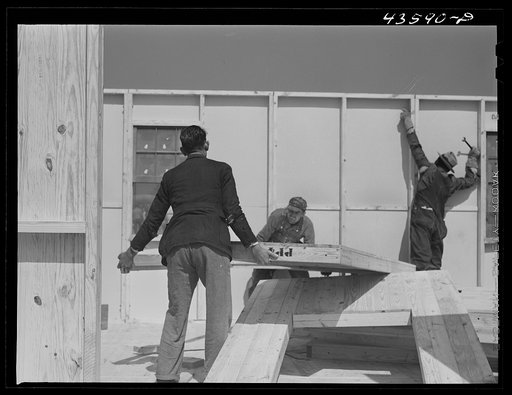 Untitled photo, possibly related to: Getting up the walls on a prefabricated house being built by FSA (Farm Security Administration) to house some of the farmers when they move out of the Spartanburg Army camp area. Pacolet, South Carolina region