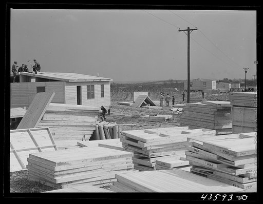 Building prefabricated houses for farmers who had to move out of the Camp Croft area. "Ready made" sections are in foreground. Pacolet, South Carolina region