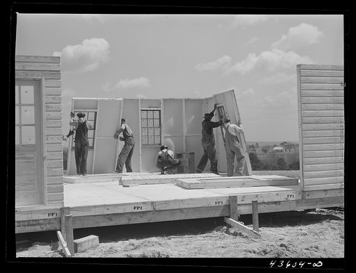Getting up the walls on a prefabricated house being built by FSA (Farm Security Administration) to house some of the farmers when they move out of the Spartanburg Army camp area. Pacolet, South Carolina region