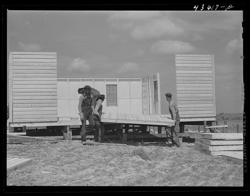 Putting up a wall on a prefabricated house that is being built by FSA (Farm Security Administration) to house some of the farmers who had to move out of the Spartanburg Army camp area. Pacolet, South Carolina