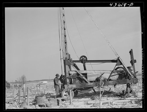 Untitled photo, possibly related to: Digging a well for families moving into FSA (Farm Security Administration) prefabricated houses from the Camp Croft area. Pacolet, South Carolina region