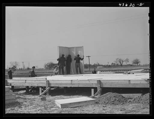 The first walls go up after the foundation has been built on prefabricated houses built by FSA (Farm Security Administration) to house some of the farmers who had to move out of the Camp Croft area region