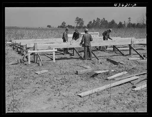 Building the foundation for a prefabricated house that FSA (Farm Security Administration) is putting up to house some farmers who had to move out of the Camp Croft area region