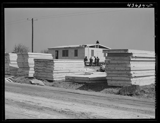 Untitled photo, possibly related to: Building prefabricated houses for farmers who had to move out of the Camp Croft area. "Ready made" sections are in foreground. Pacolet, South Carolina region
