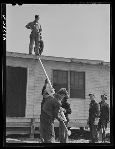 Putting the roof on a prefabricated house at the FSA (Farm Security Administration) project. Pacolet, South Carolina