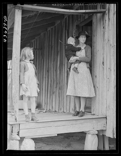 A tenant family in the Camp Croft area watching their belongings being moved out. Near Whitestone, South Carolina