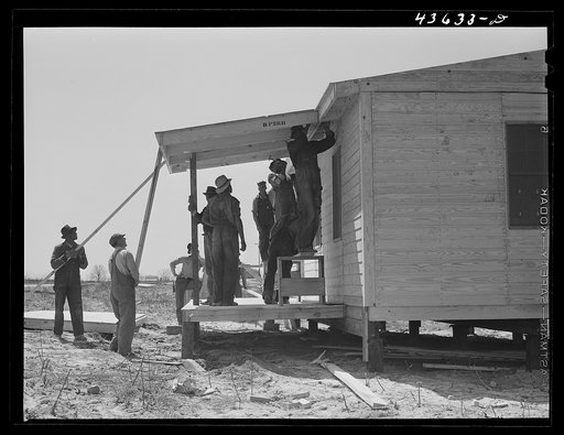 Putting the porch on a prefabricated house built near Pacolet, South Carolina by the FSA (Farm Security Administration) for farmers who had to move out of the Camp Croft area. Pacolet, South Carolina region