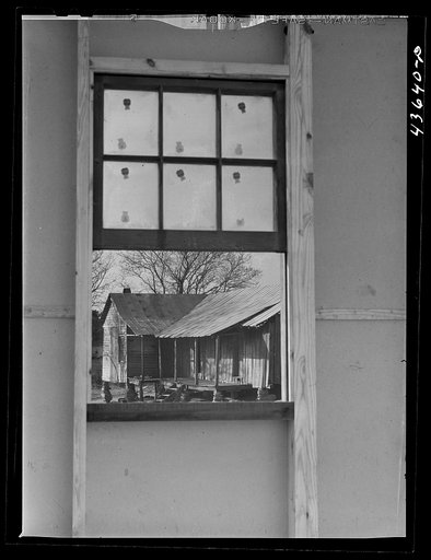 Old tenant house seen thru window of the prefabricated houses on the FSA (Farm Security Administraton) project in the Pacolet, South Carolina region