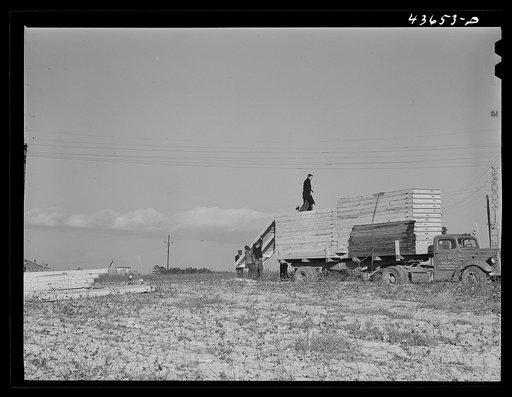 Sections of prefabricated house being unloaded from truck at the FSA (Farm Security Administration) project in Pacolet, South Carolina