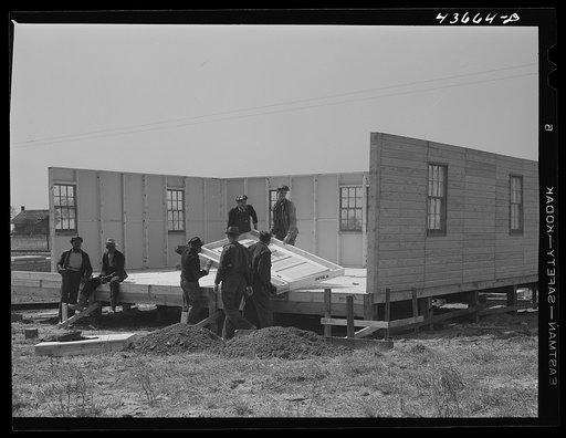 Assembling the fourth wall of a prefabricated house at the FSA (Farm Security Administration) project in Pacolet to house some of the farmers moving out of the Camp Croft area. Pacolet, South Carolina